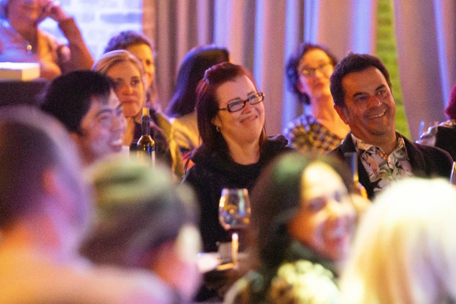 Guests laughing together at their table during a show