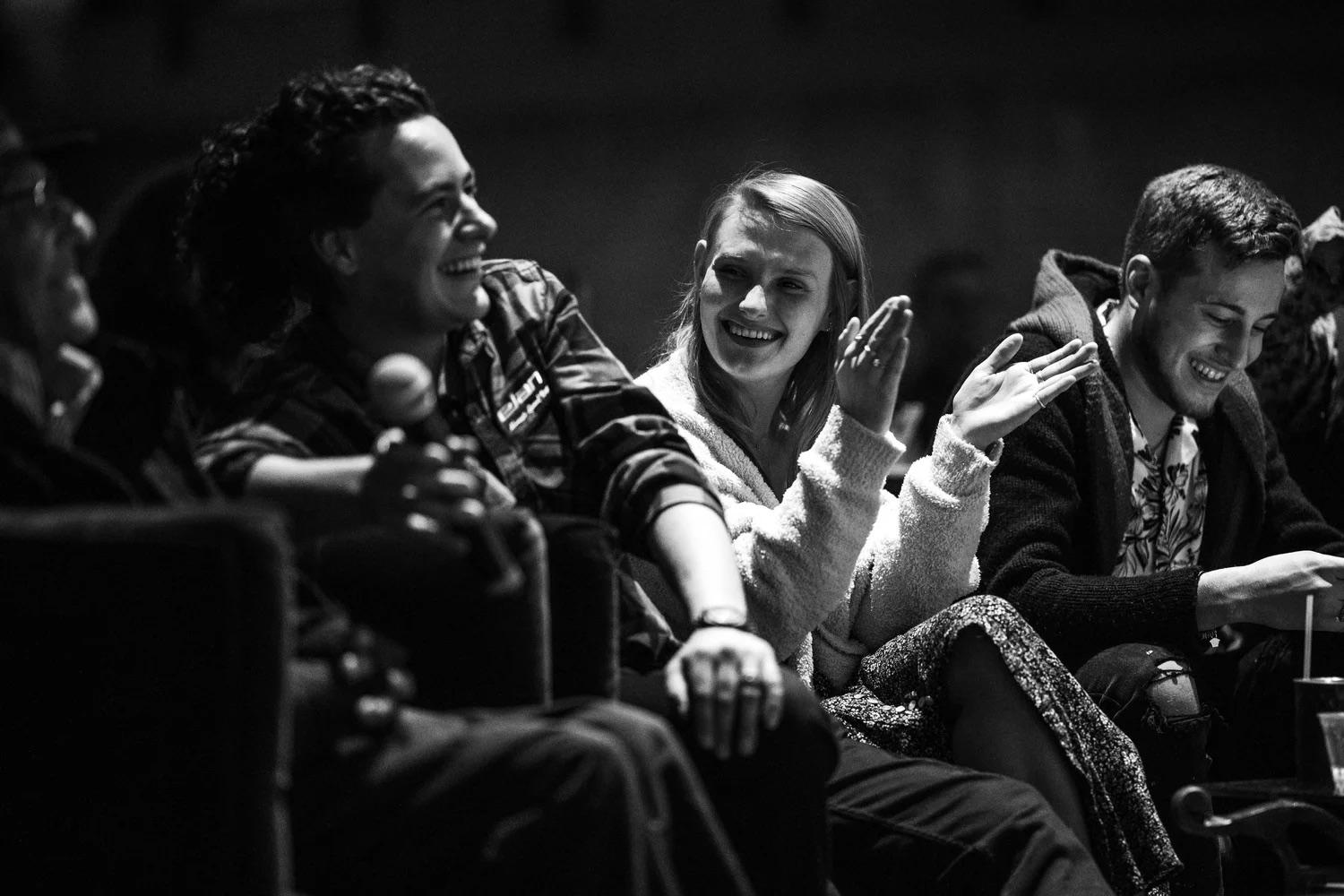 Audience members laughing and cheering